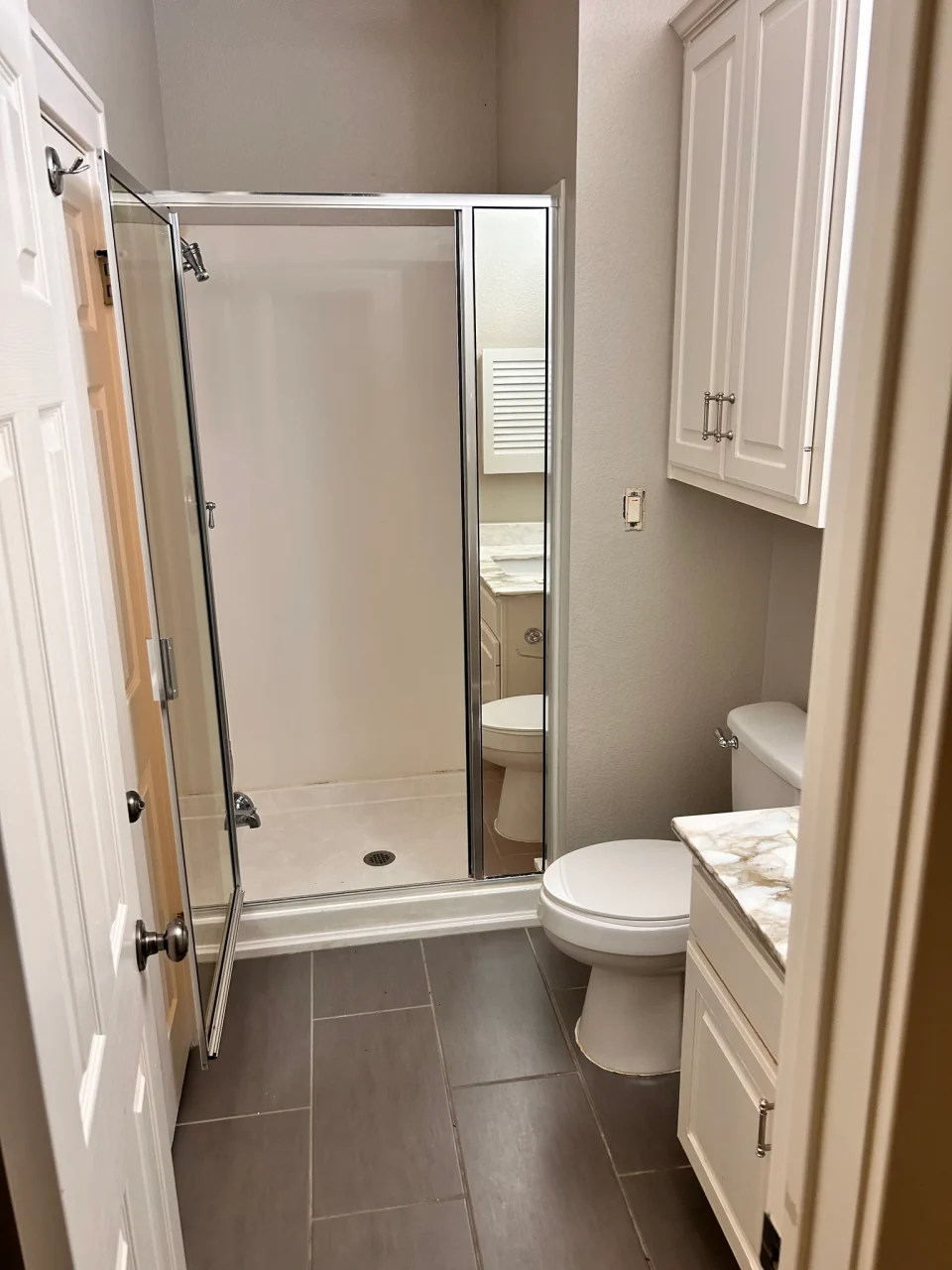 Before renovation: original shower viewed from the bathroom doorway