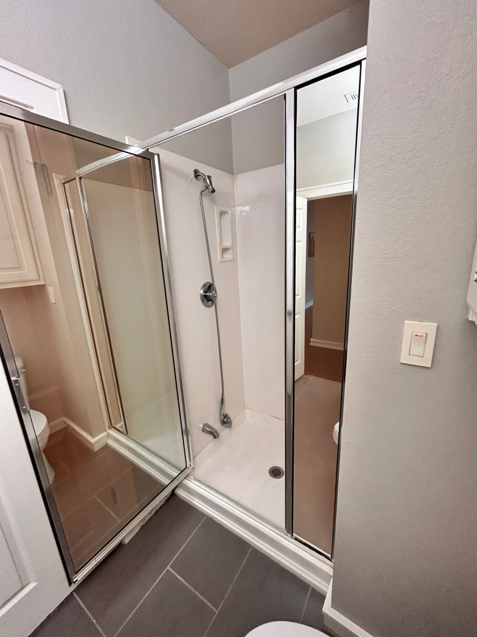 Before renovation: angled view of the original shower enclosure