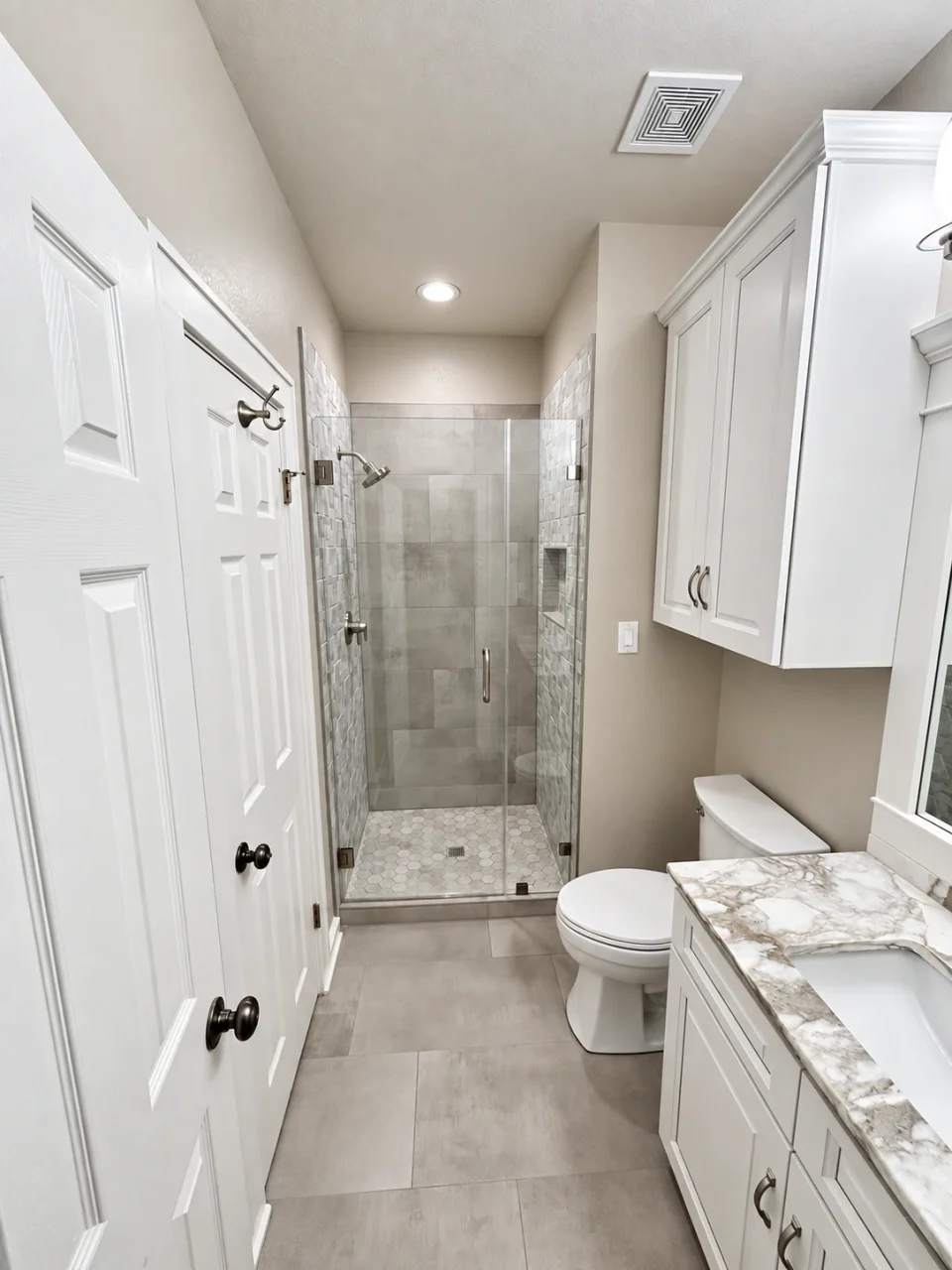 Finished bathroom: shower, toilet and vanity from the doorway
