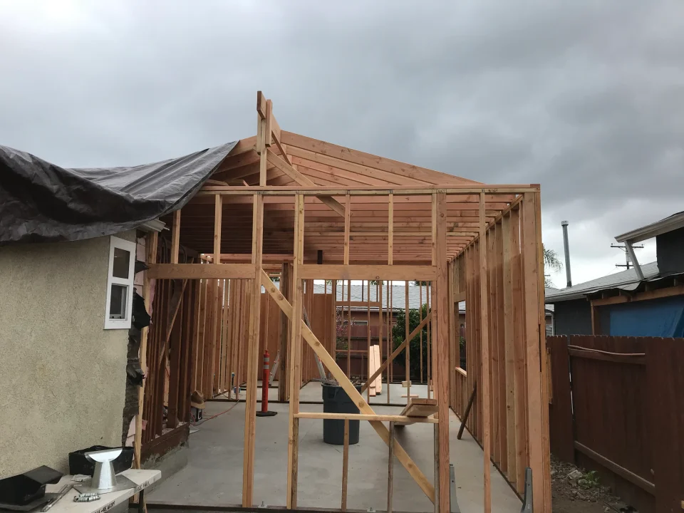 Attached ADU timber framing beside the existing house