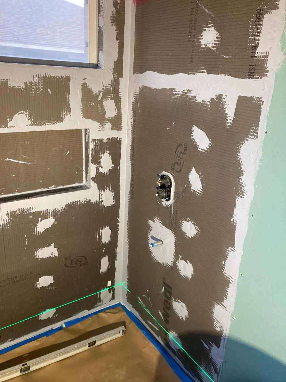 Waterproof shower wall boards with sealed seams before tile