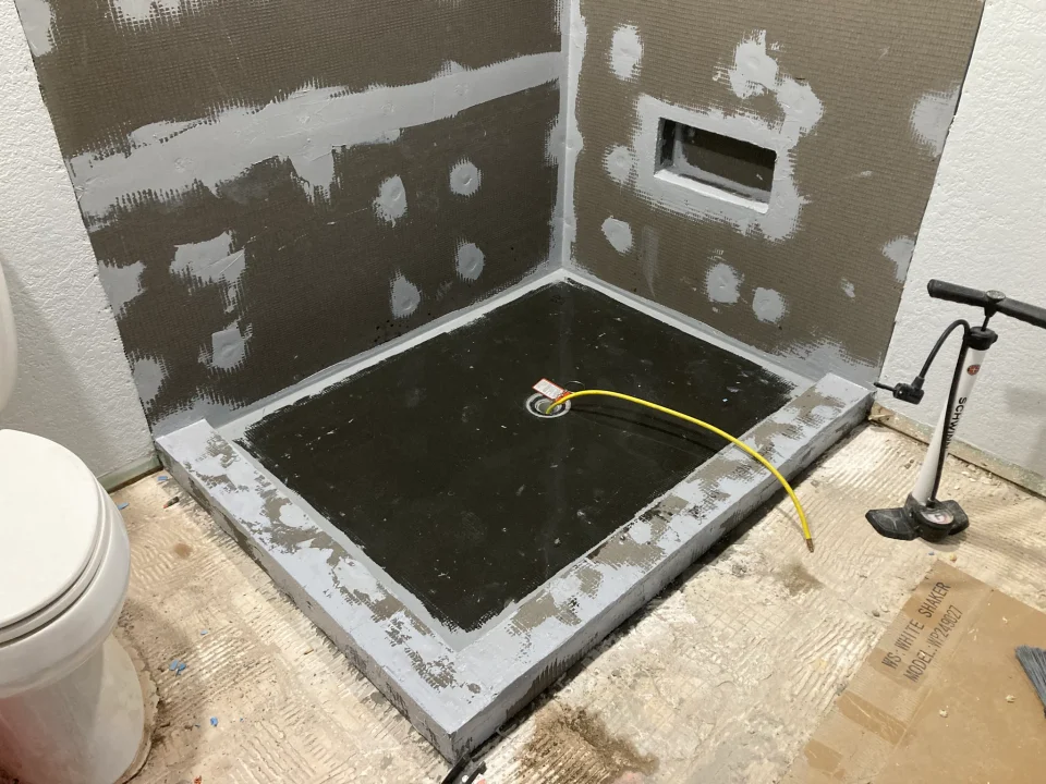 Water-filled shower pan during a flood test