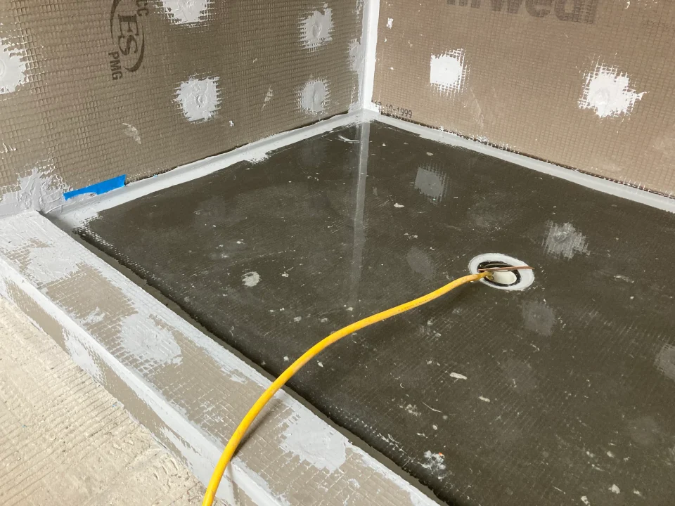 Water-filled shower pan and sealed wall boards during flood testing