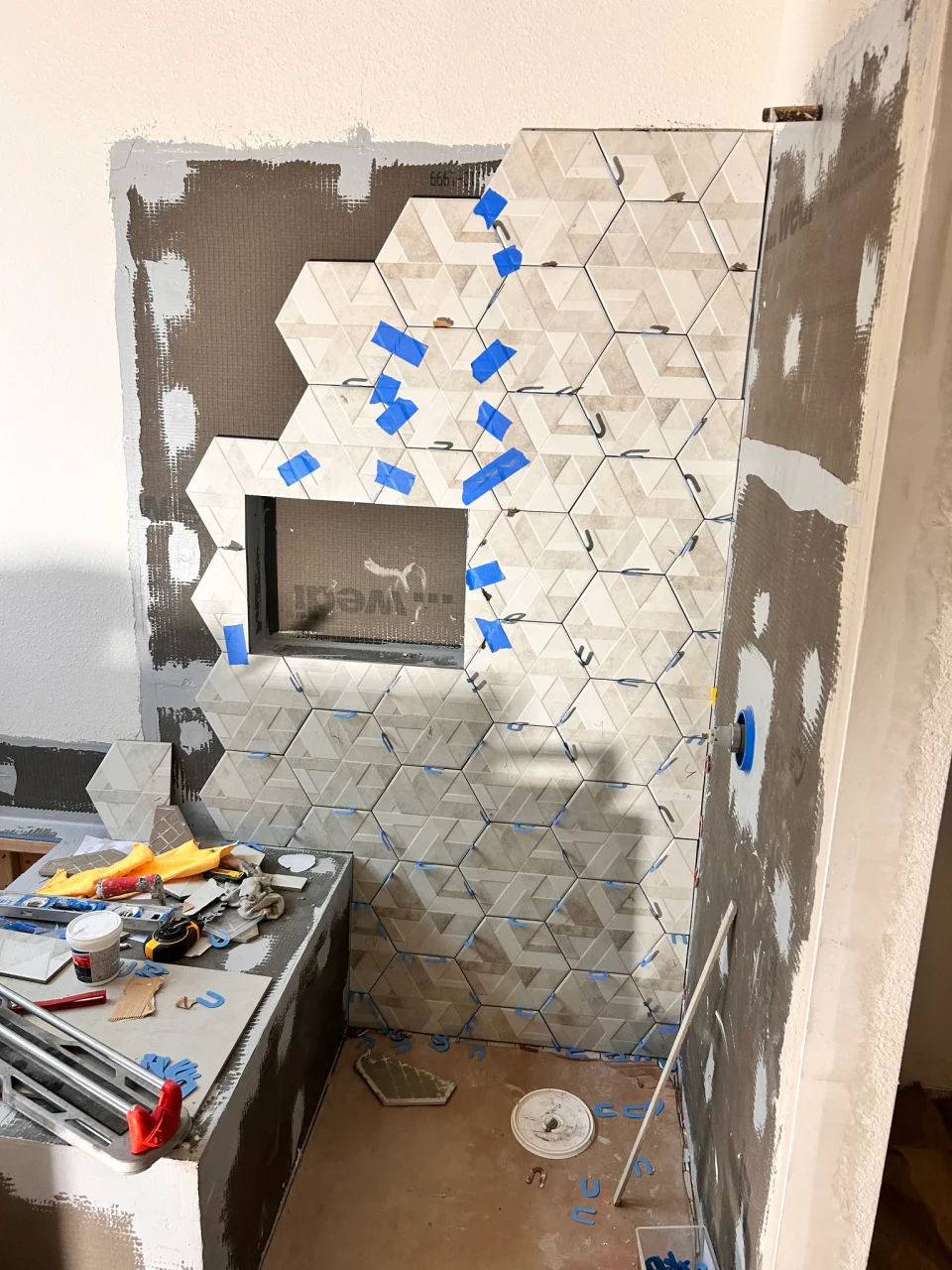 Textured shower wall tile during installation