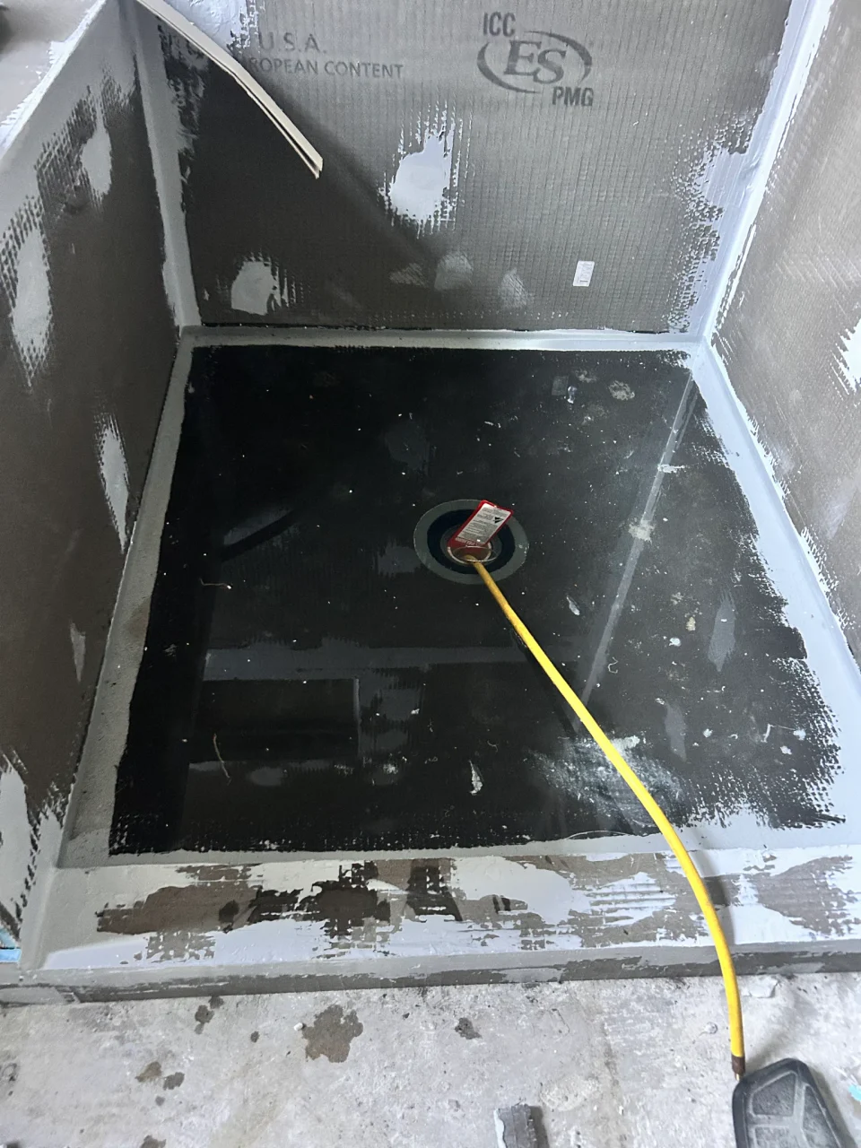 Water-filled shower pan during flood testing