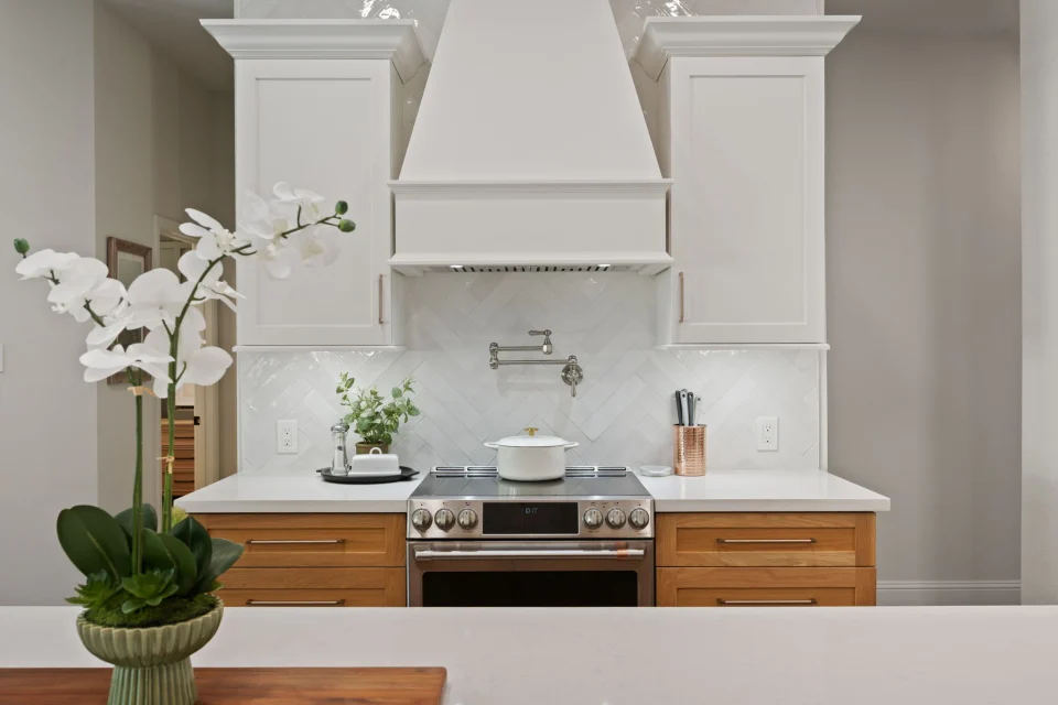 Custom white range hood above the kitchen counter