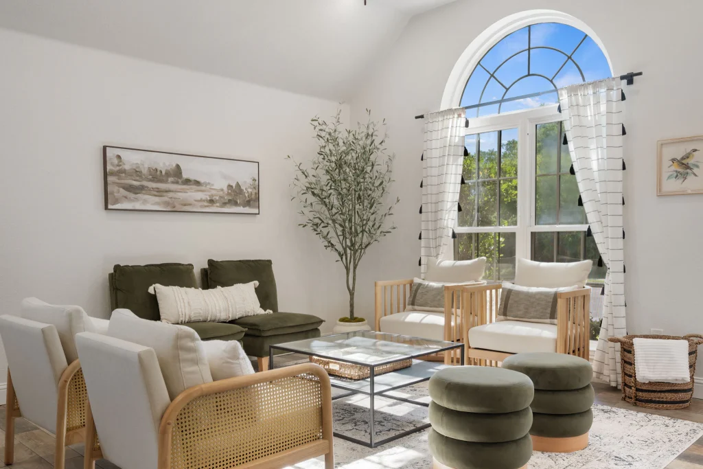 Living room seating beside the arched window