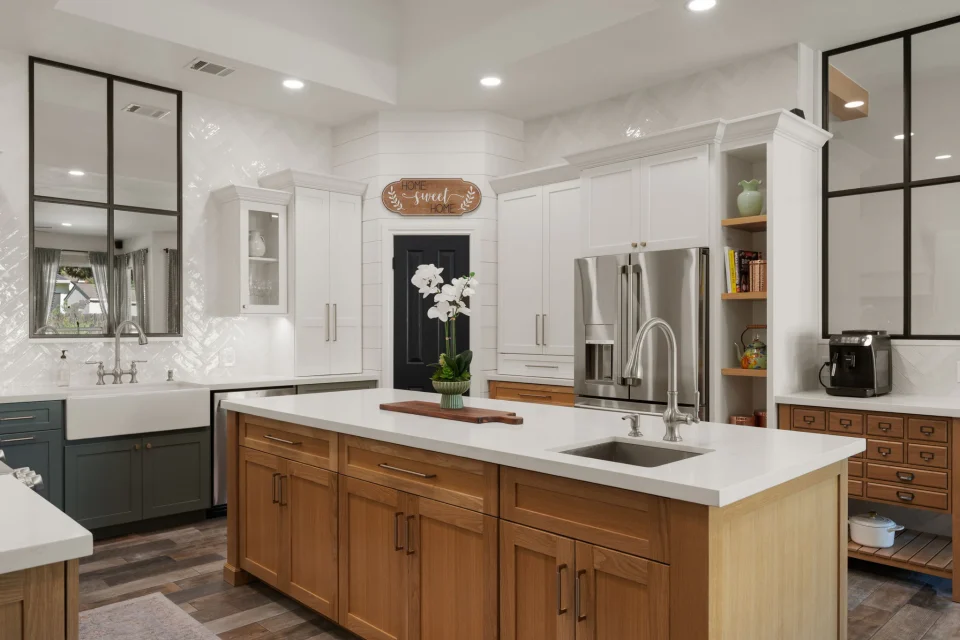 Wood kitchen island with white cabinetry and glass-front partitions
