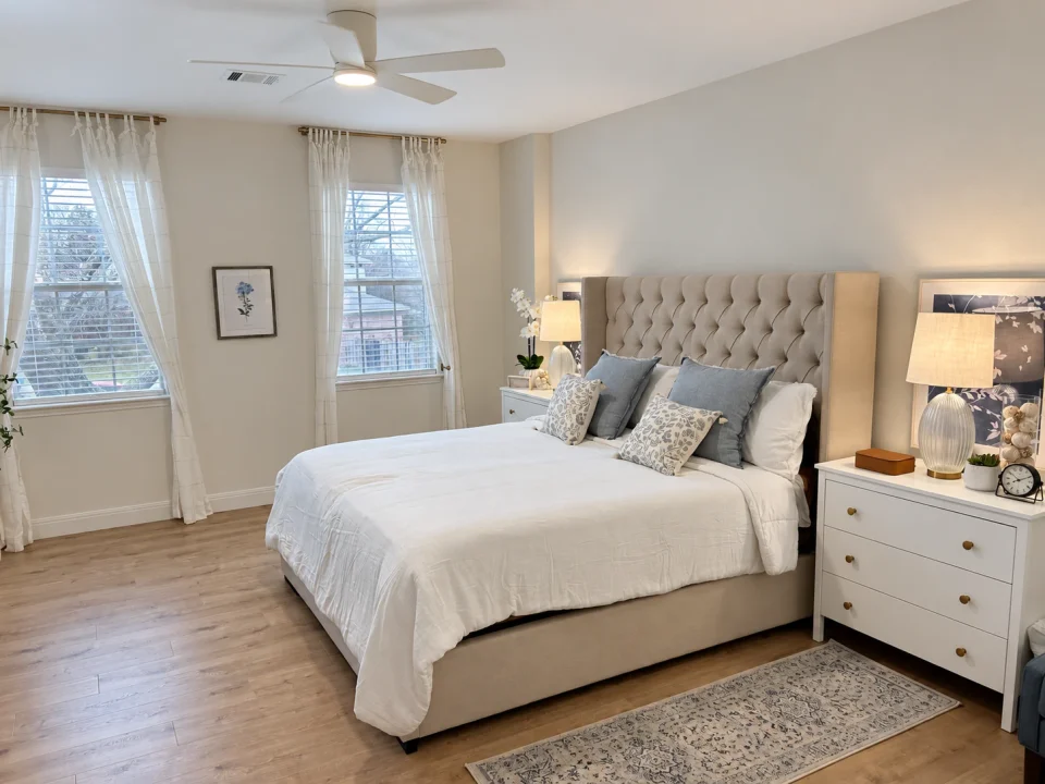 Bedroom with upholstered bed and light bedding