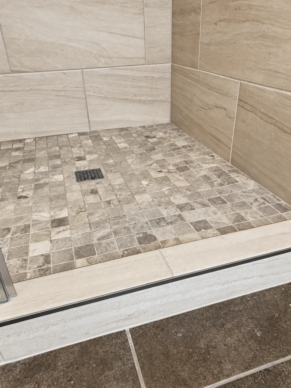 Mosaic shower floor and tiled threshold
