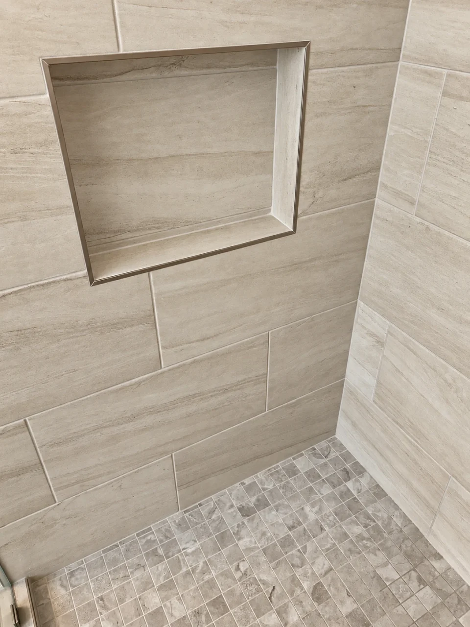 Recessed niche in warm-toned shower tile