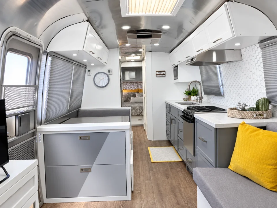 Renovated Airstream interior with silver walls and light cabinetry