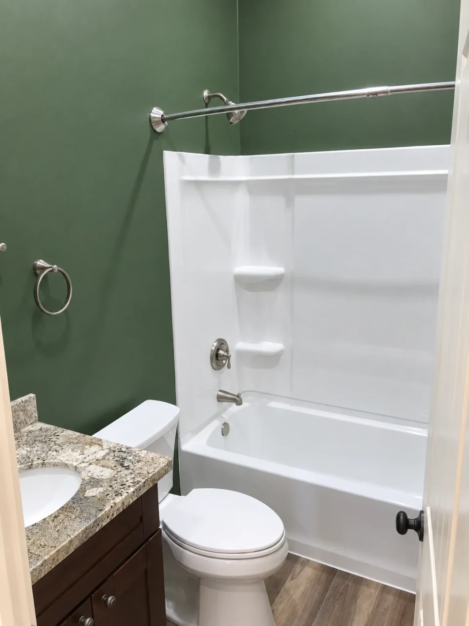 Attached ADU bathroom with white tub and green walls